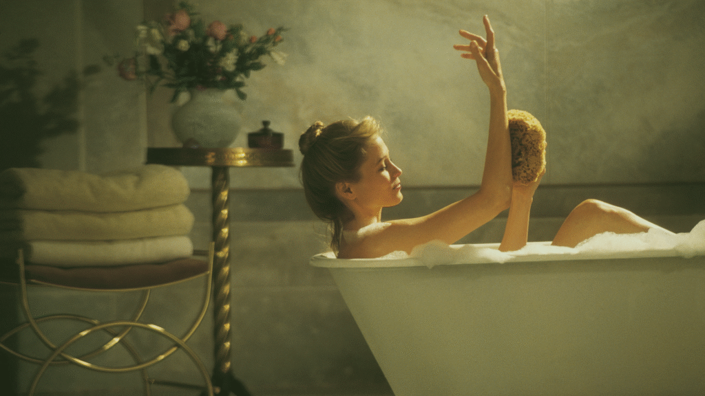 Girl taking a shower using hot water heat pump which is financially supported by government rebates with application through AERA